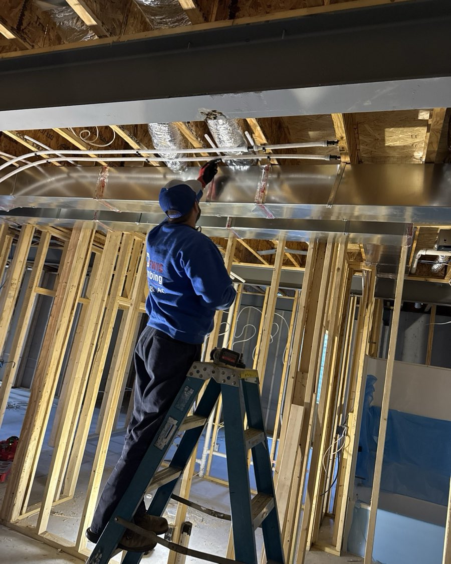 A Perfect Climate technician running new ductwork at a Southwest Indiana home